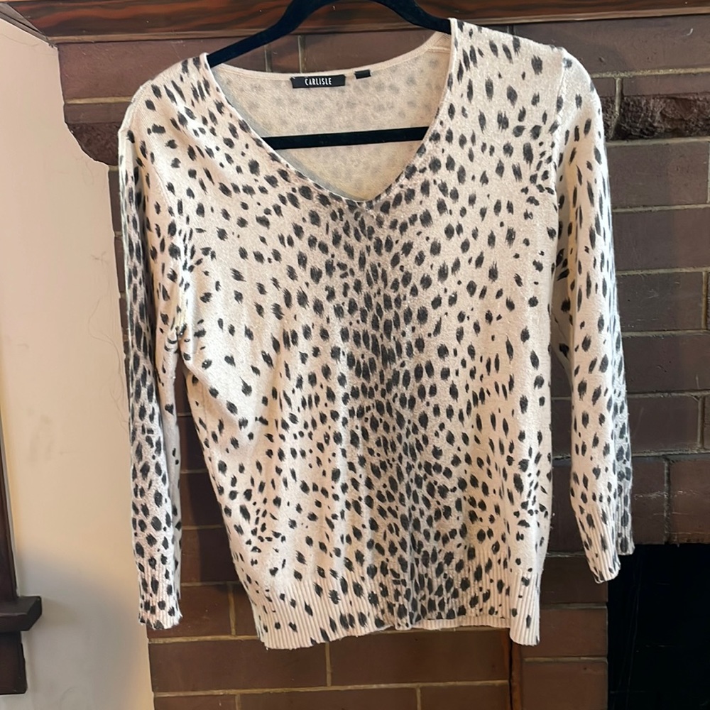 CARLISLE cheetah print sweater with three-quarter length sleeves.